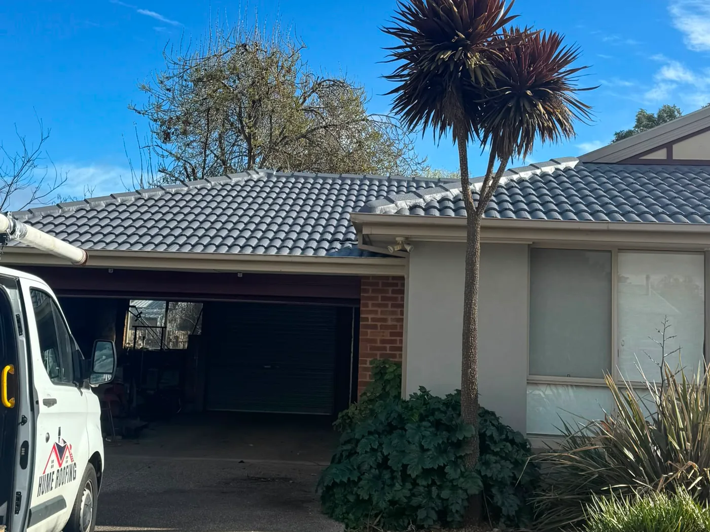 Completed Hume Roofing roof restoration with company service vehicle