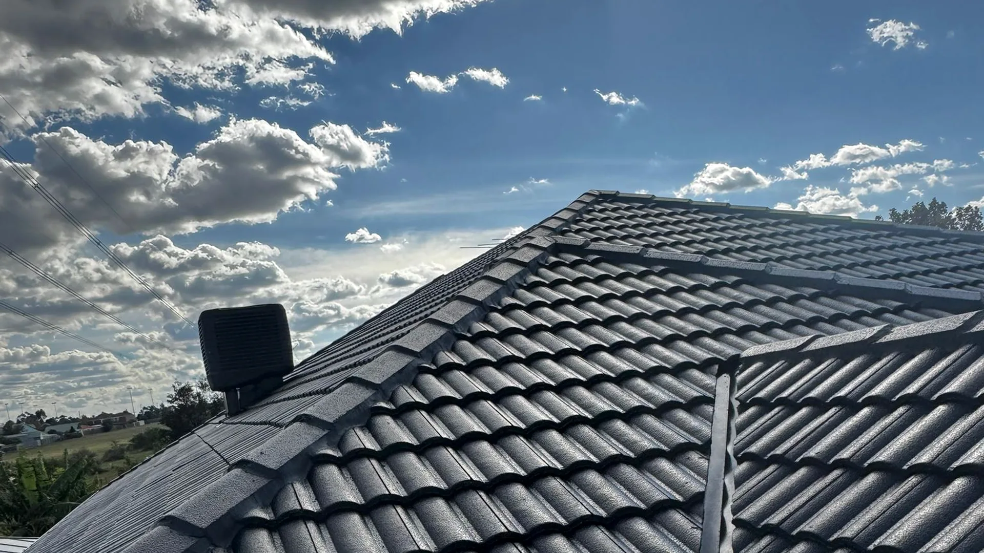 Completed roof restoration by Hume Roofing with company service van