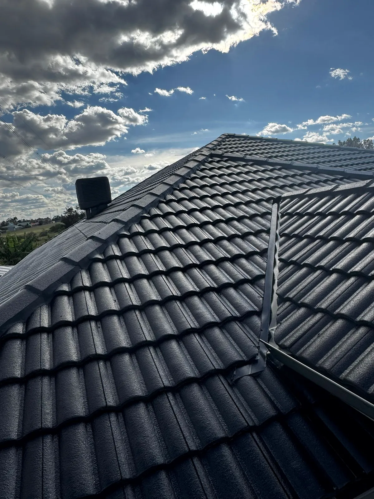 Completed dark roof coating and restoration