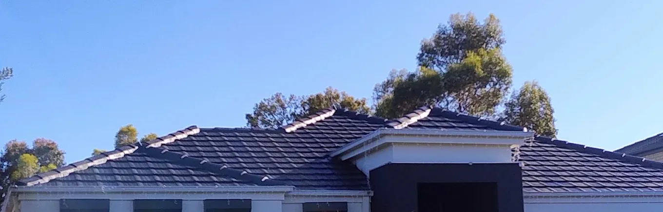 Wide view of completed dark tile roof