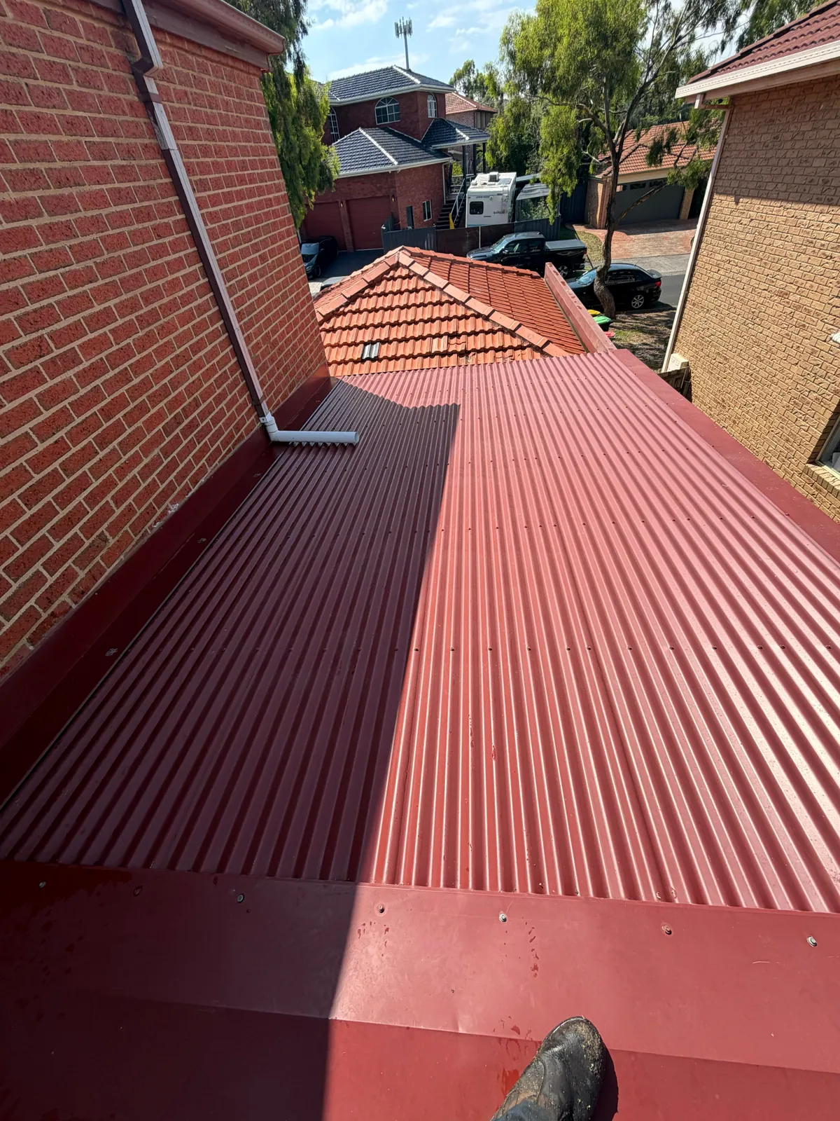 Completed red metal roofing installation