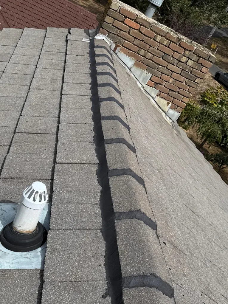 Roof flashing and tile repair work near a chimney