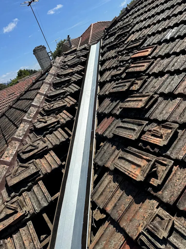Roof tiles lifted for valley replacement